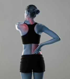 image of woman indicating back ache and neck ache